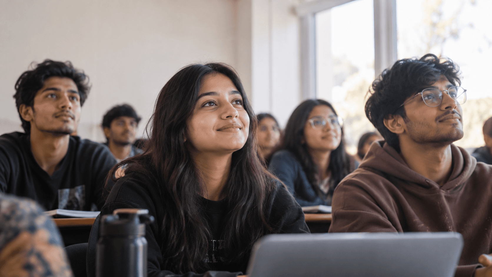 Students in a classroom, engaged and looking ahead